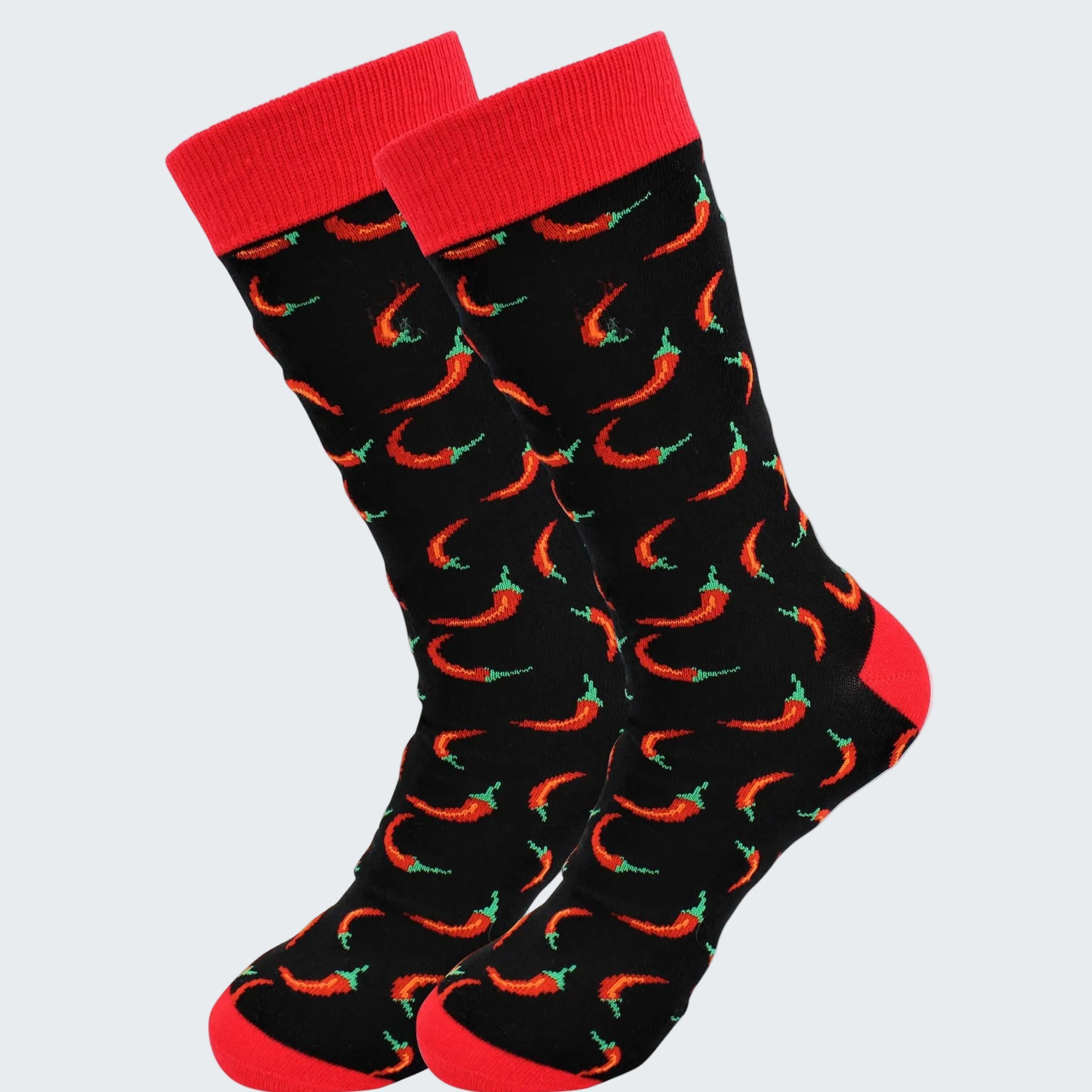 Black socks with red chili pepper pattern and red cuffs on a white background