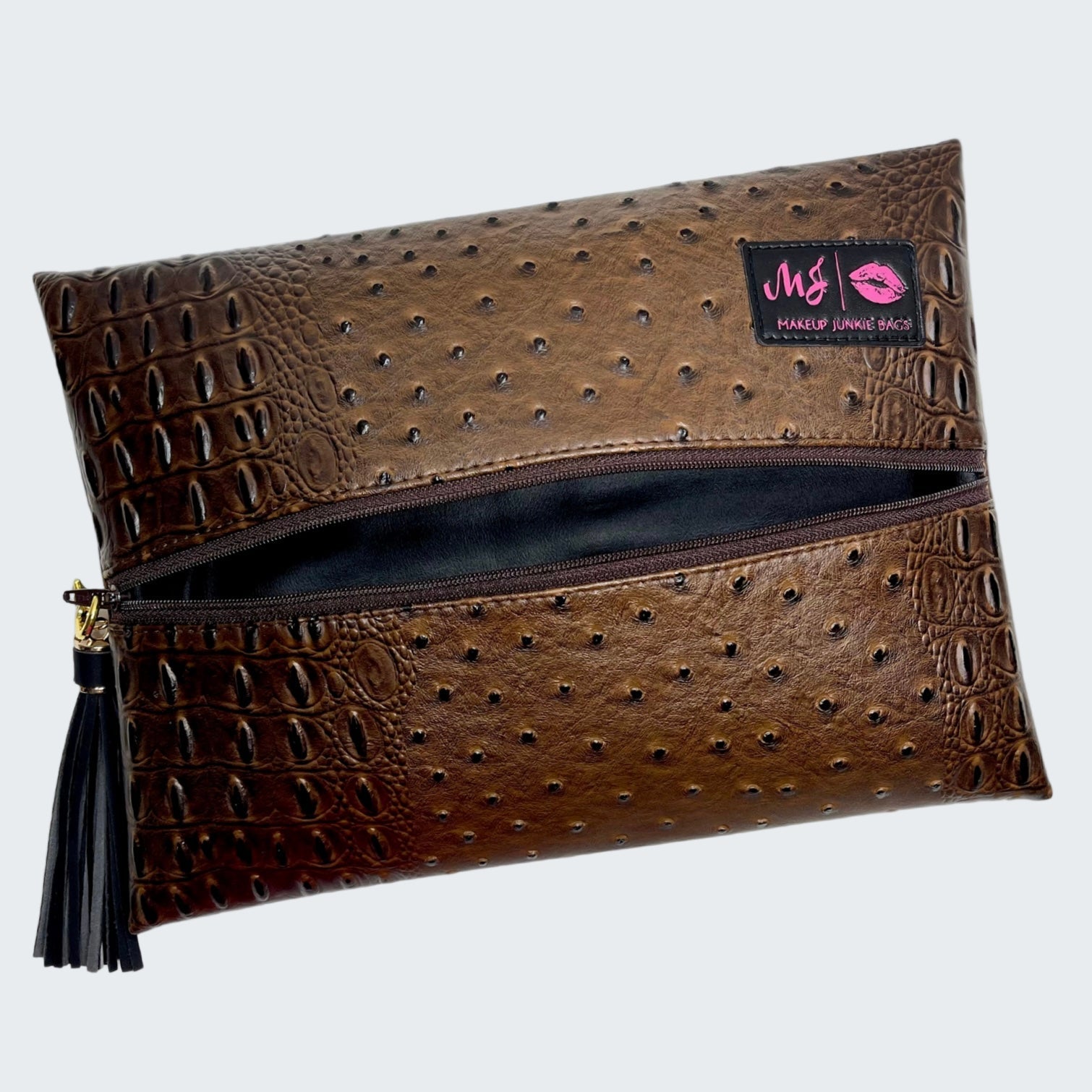 Brown textured clutch bag with a visible brand label on a white background