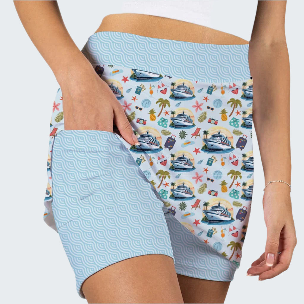 Shorts with a colorful pattern of boats, palm trees, and stars on a light blue background.