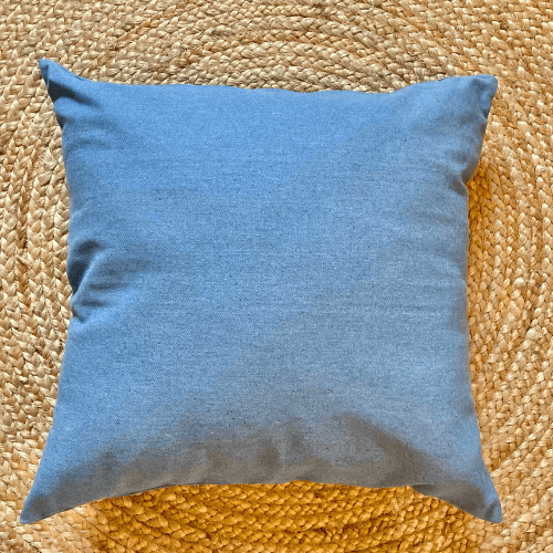Blue pillow on a textured woven surface