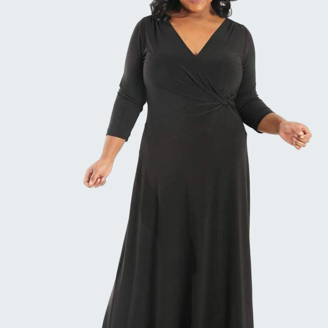 Woman wearing a black long-sleeve dress on a white background