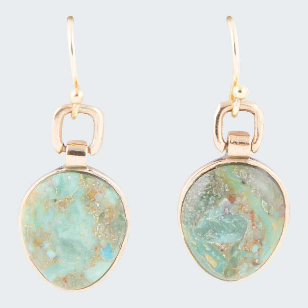 Gold earrings with turquoise stone on a white background