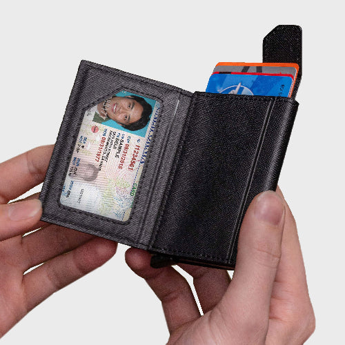 Black wallet with cards and an ID card held by a hand on a white background