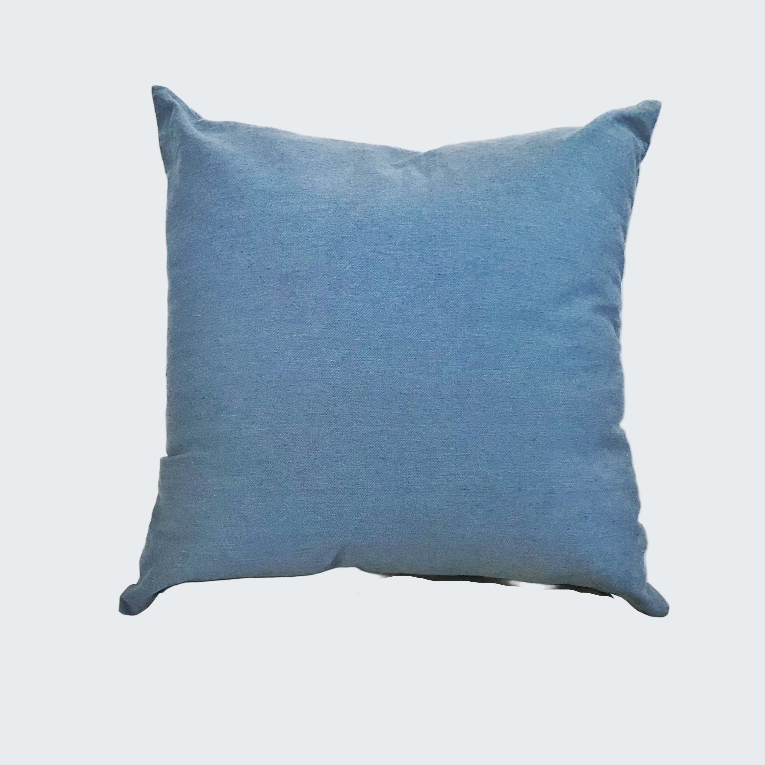 Blue pillow on a wooden stool against a white background
