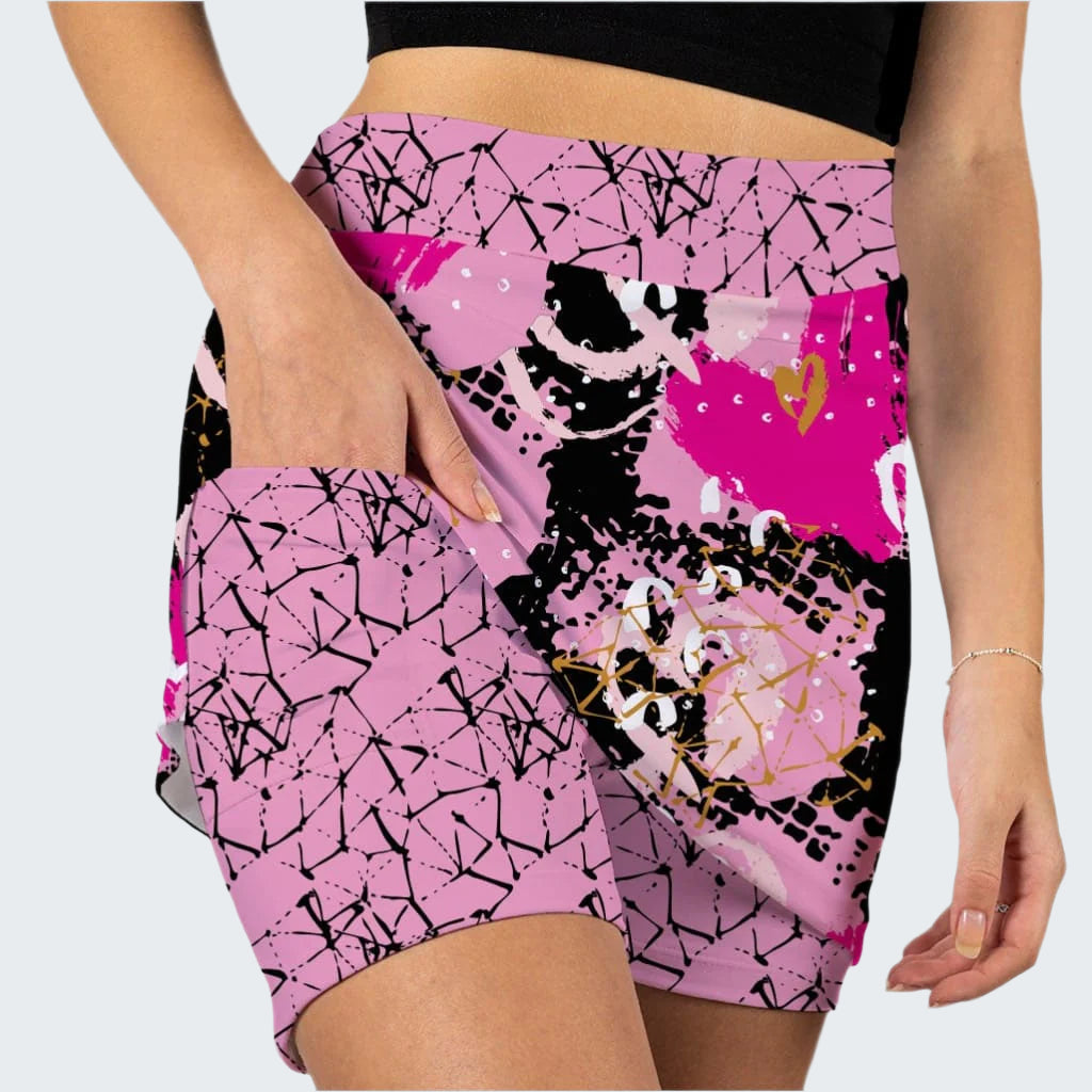 Pink and black patterned shorts worn by a person on a white background
