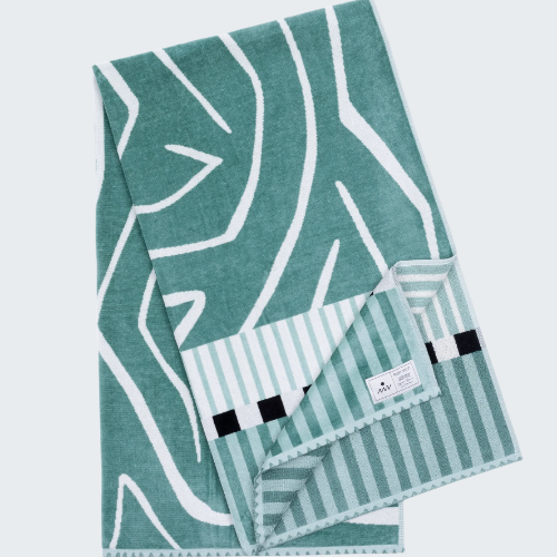 Teal towel with geometric pattern on a white background