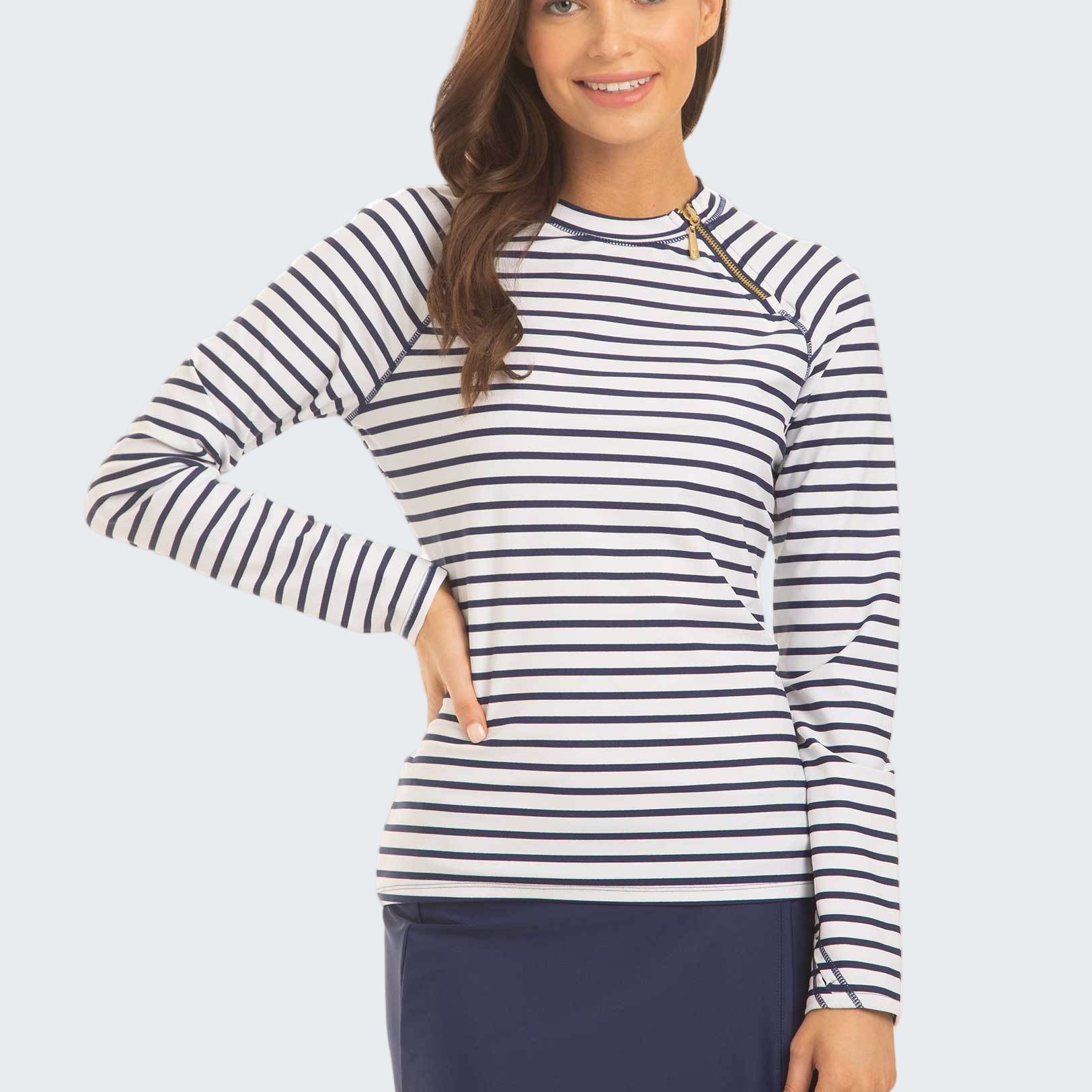 Woman wearing a striped long-sleeve top and navy skirt on a white background