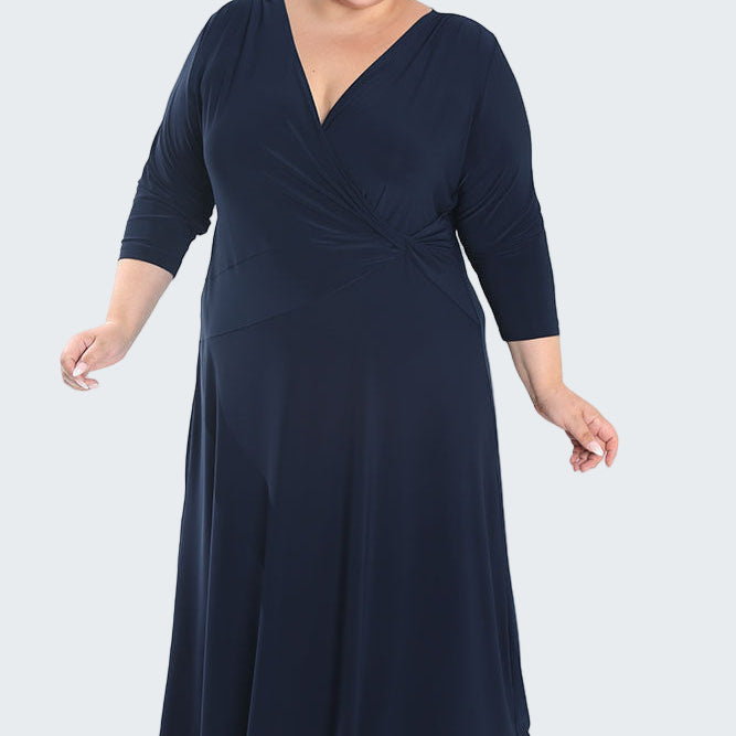 Woman wearing a navy blue dress on a white background