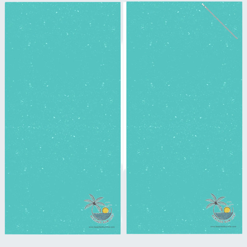Two turquoise towels with a palm tree and sun design on a white background, labeled 'Ocean Vibes'.