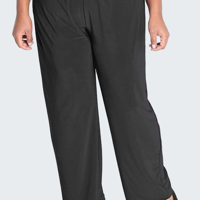 Person wearing black wide-leg pants on a white background