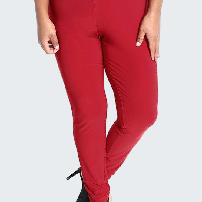 Red pants worn by a person on a white background
