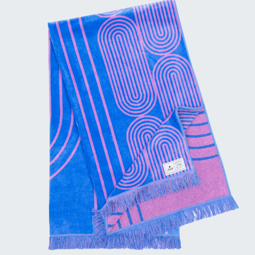 Blue and pink patterned towel with frayed edges on a white background
