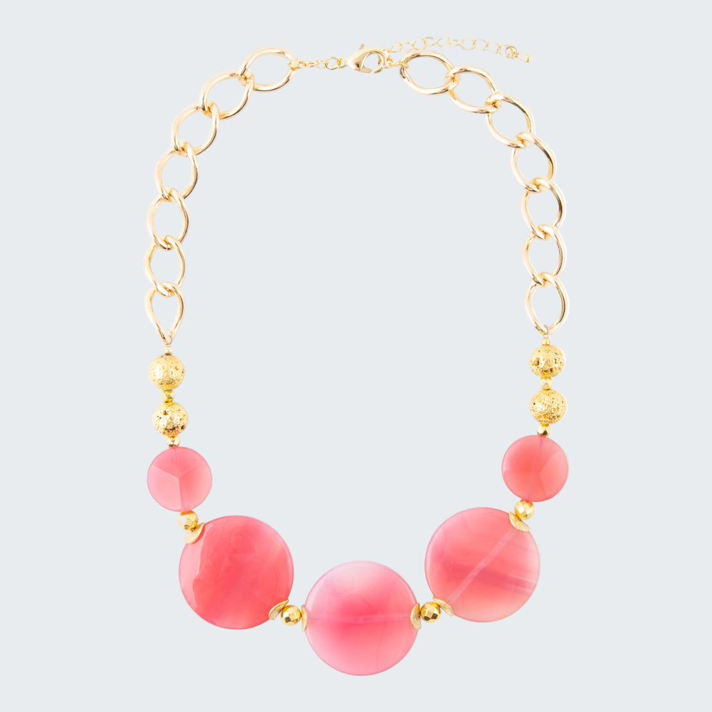 Necklace with pink beads and gold chain on a white background