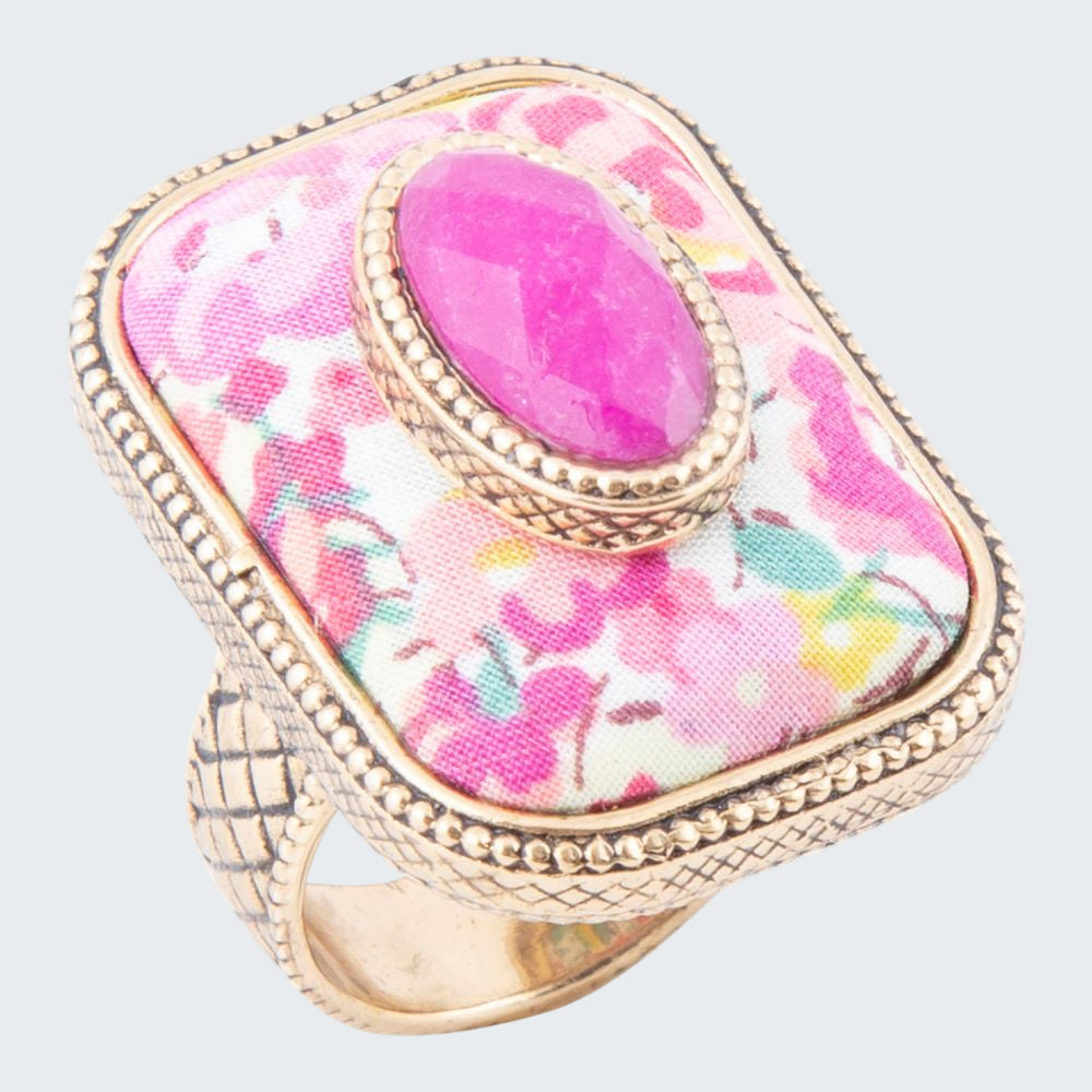 Ring with pink floral pattern and gold accents on a white background