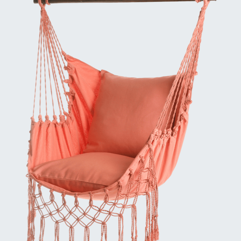 Coral hammock chair with tassels on a white background