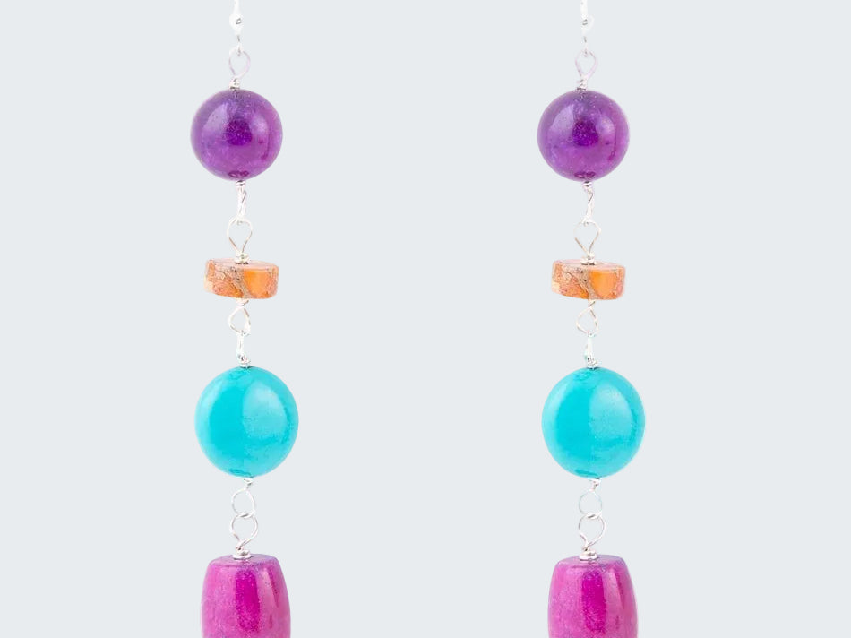 Pair of earrings with colorful beads on a white background
