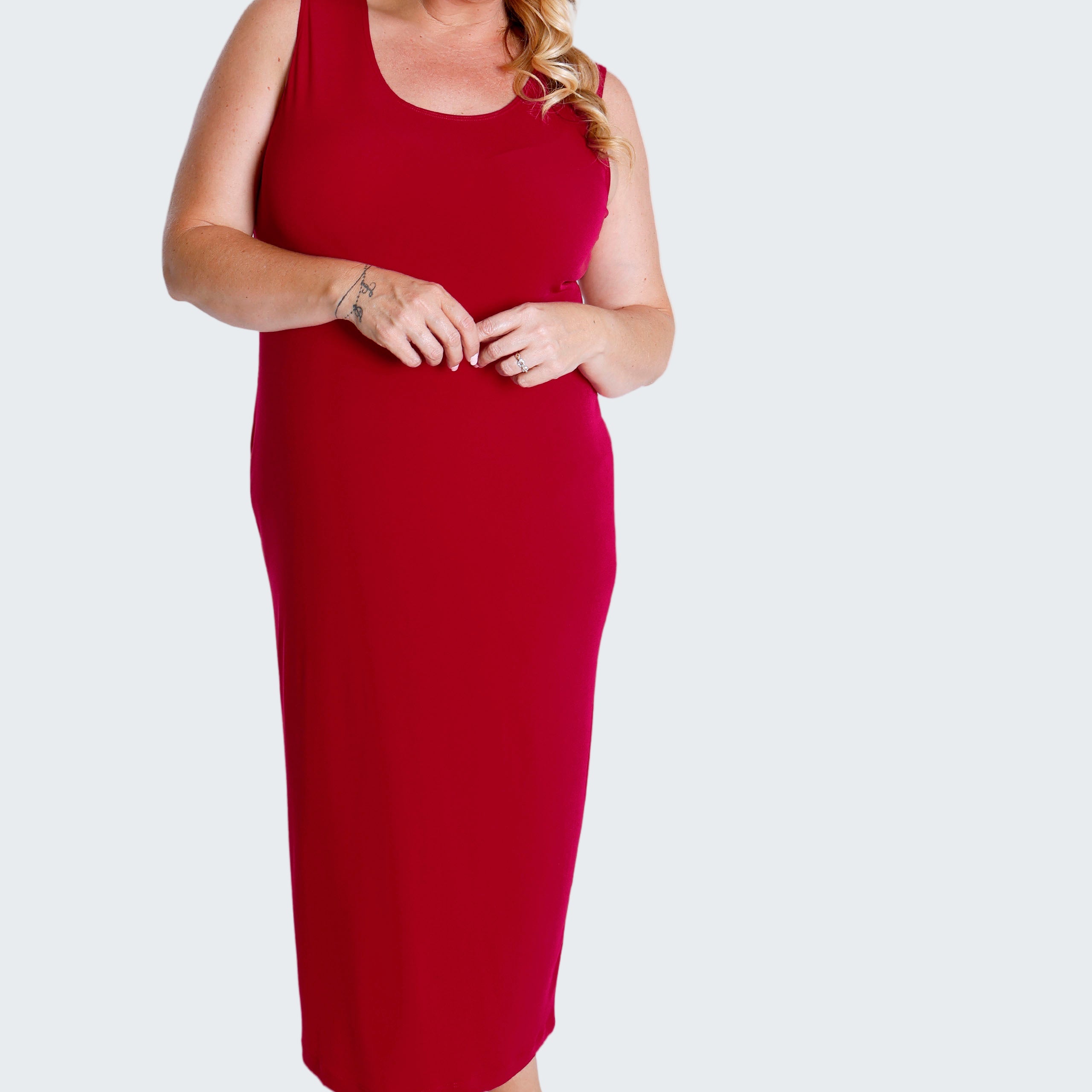 Woman wearing a red sleeveless dress on a white background