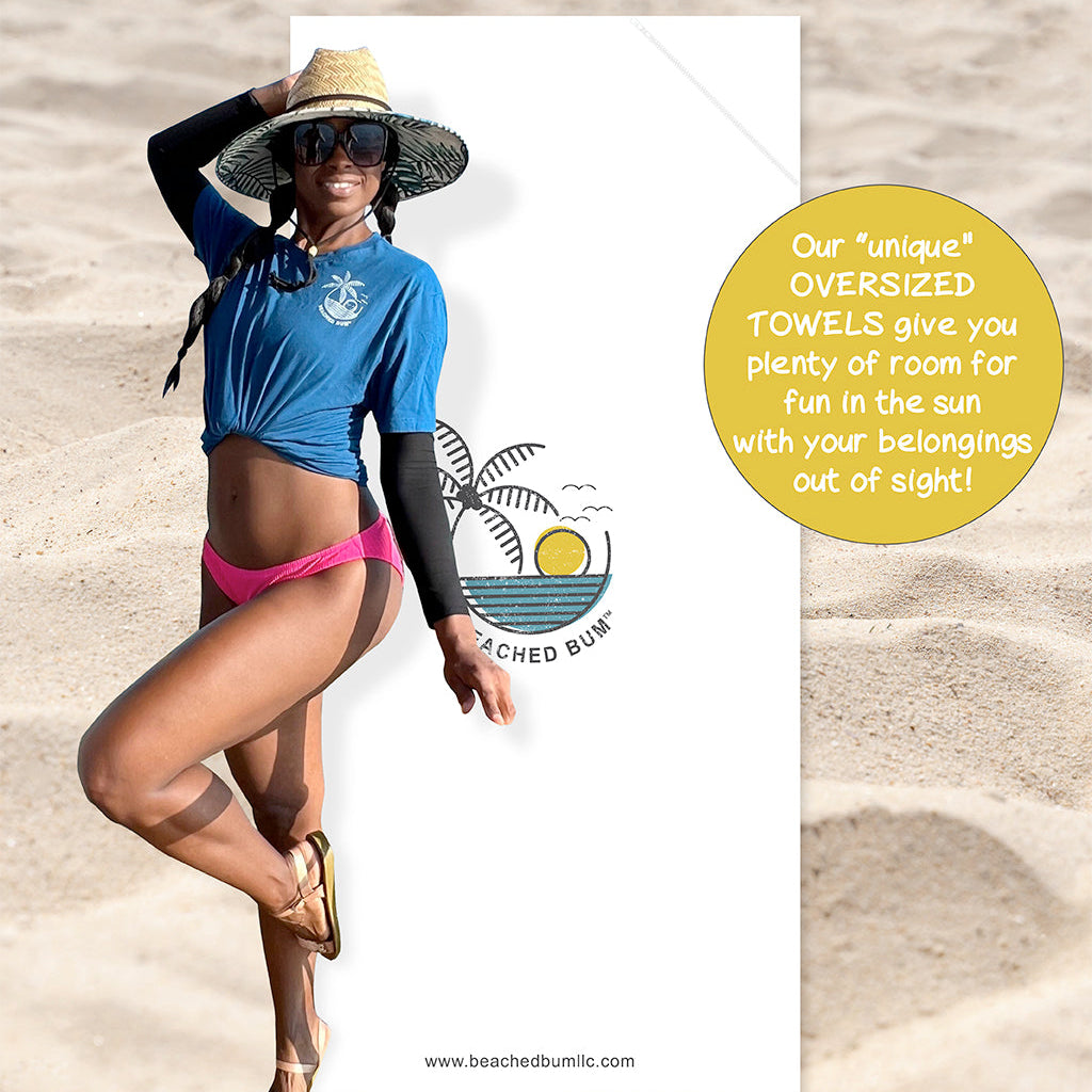 Woman in blue shirt and pink bikini on a beach with promotional text about oversized towels.