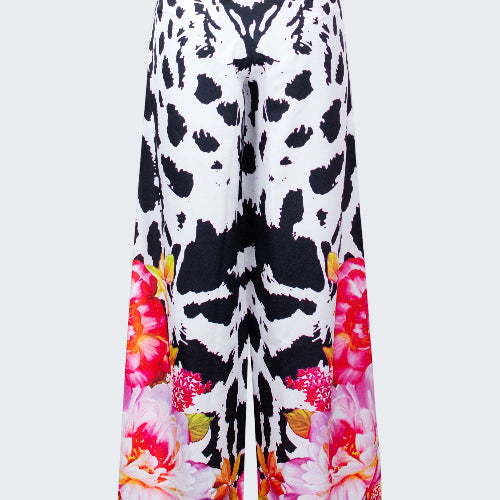Wide-leg pants with black and white abstract pattern and colorful floral design on a white background