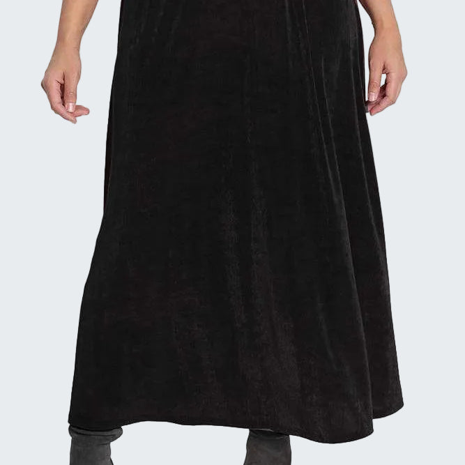 Black skirt worn by a person on a white background