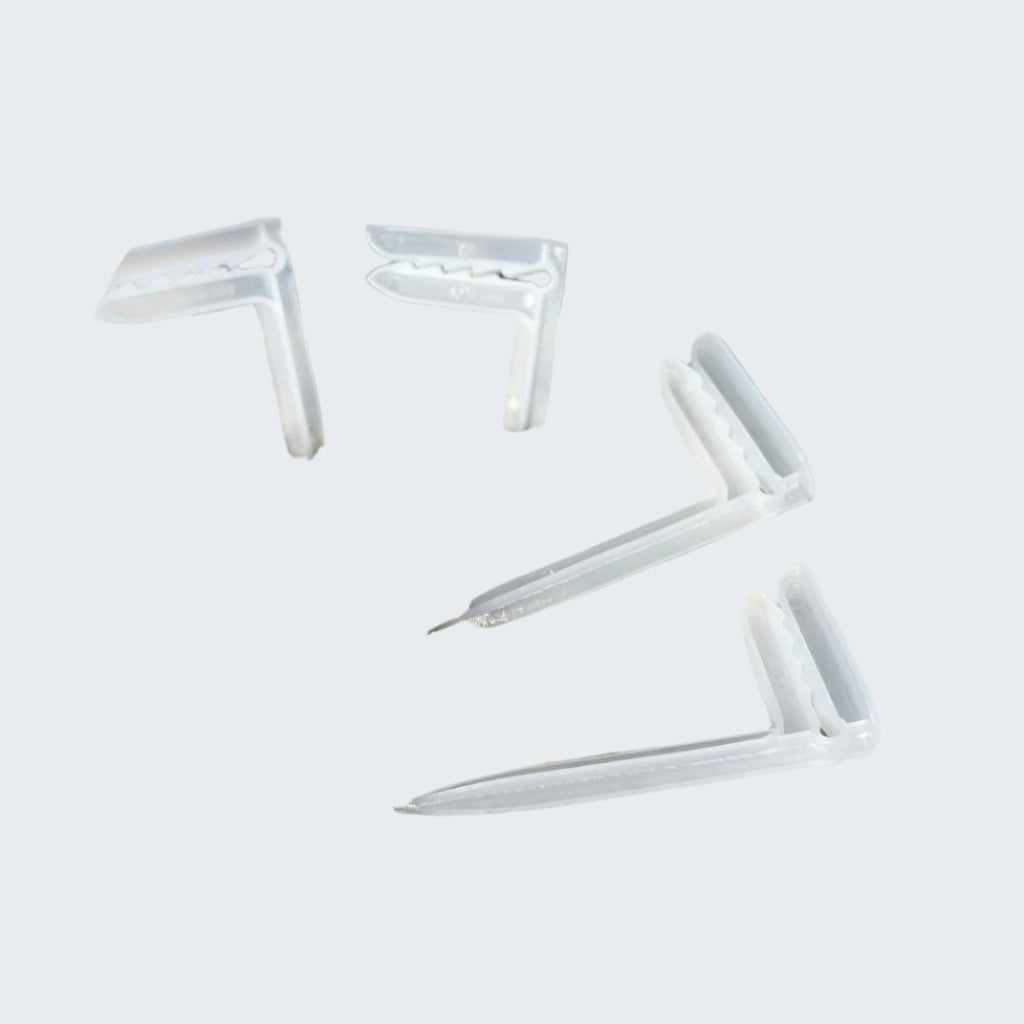 Clear white anchor on sandy beach with ocean waves