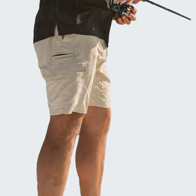 Person wearing beige shorts and a black sleeveless shirt, holding a fishing rod on a white background