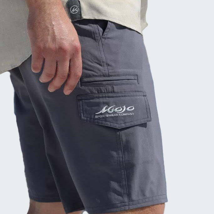 Person wearing gray shorts with a brand logo on a white background