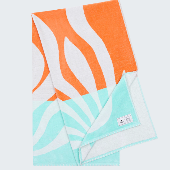 Towel with orange, white, and turquoise pattern on a white background