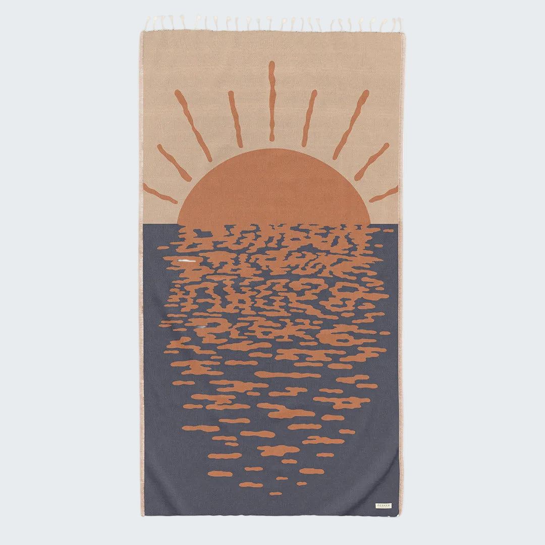 Towel with a sun and water design on a beige and blue background