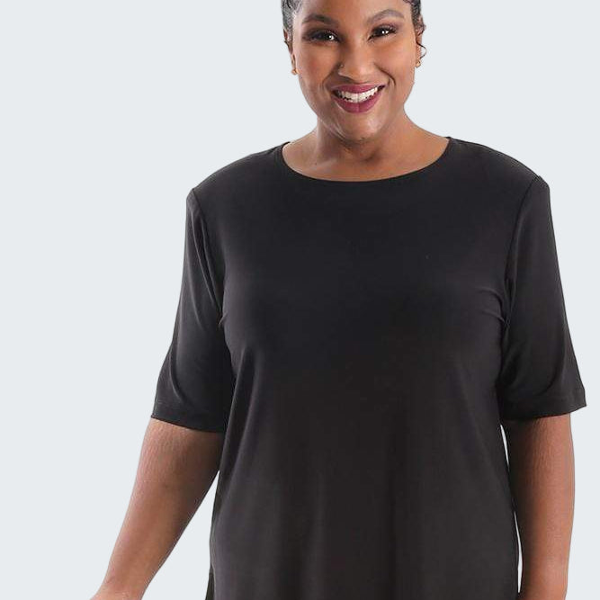 Woman wearing a black tunic with a white background