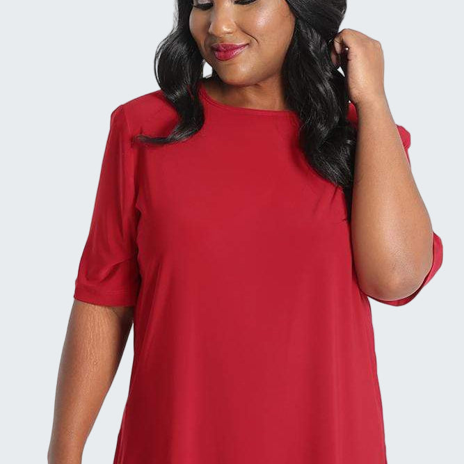Woman wearing a red top on a white background