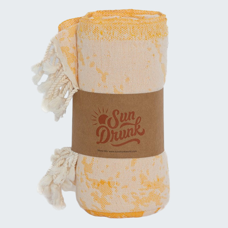 Yellow and white patterned towel with 'Sun Drunk' branding on a white background