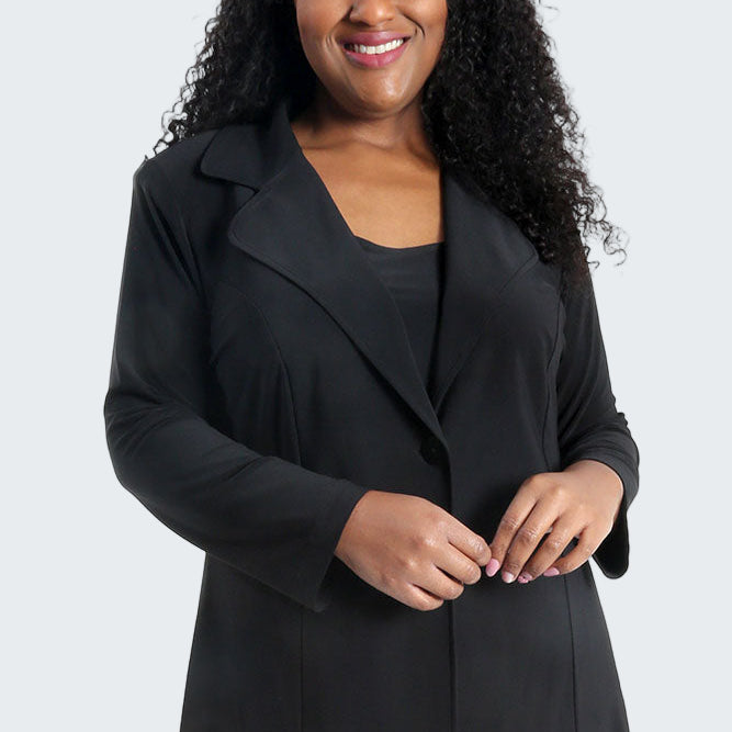 Woman wearing a black suit on a white background