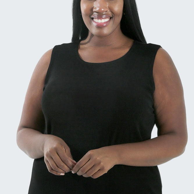 Woman wearing a black sleeveless top on a white background
