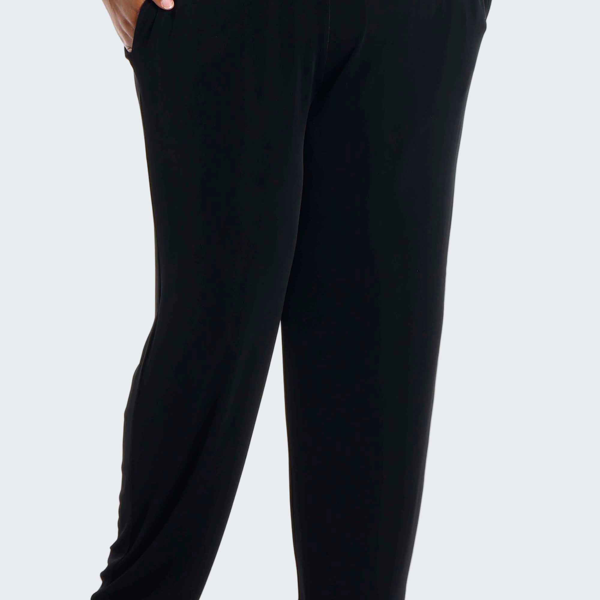 Black pants worn by a person on a white background