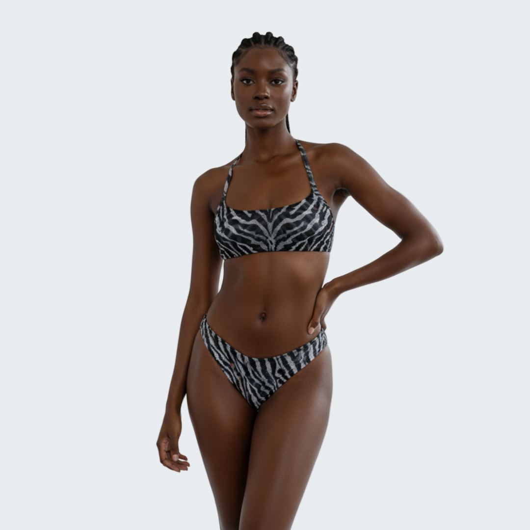 Woman wearing a zebra print bikini against a plain background