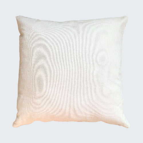 White pillow on a woven mat