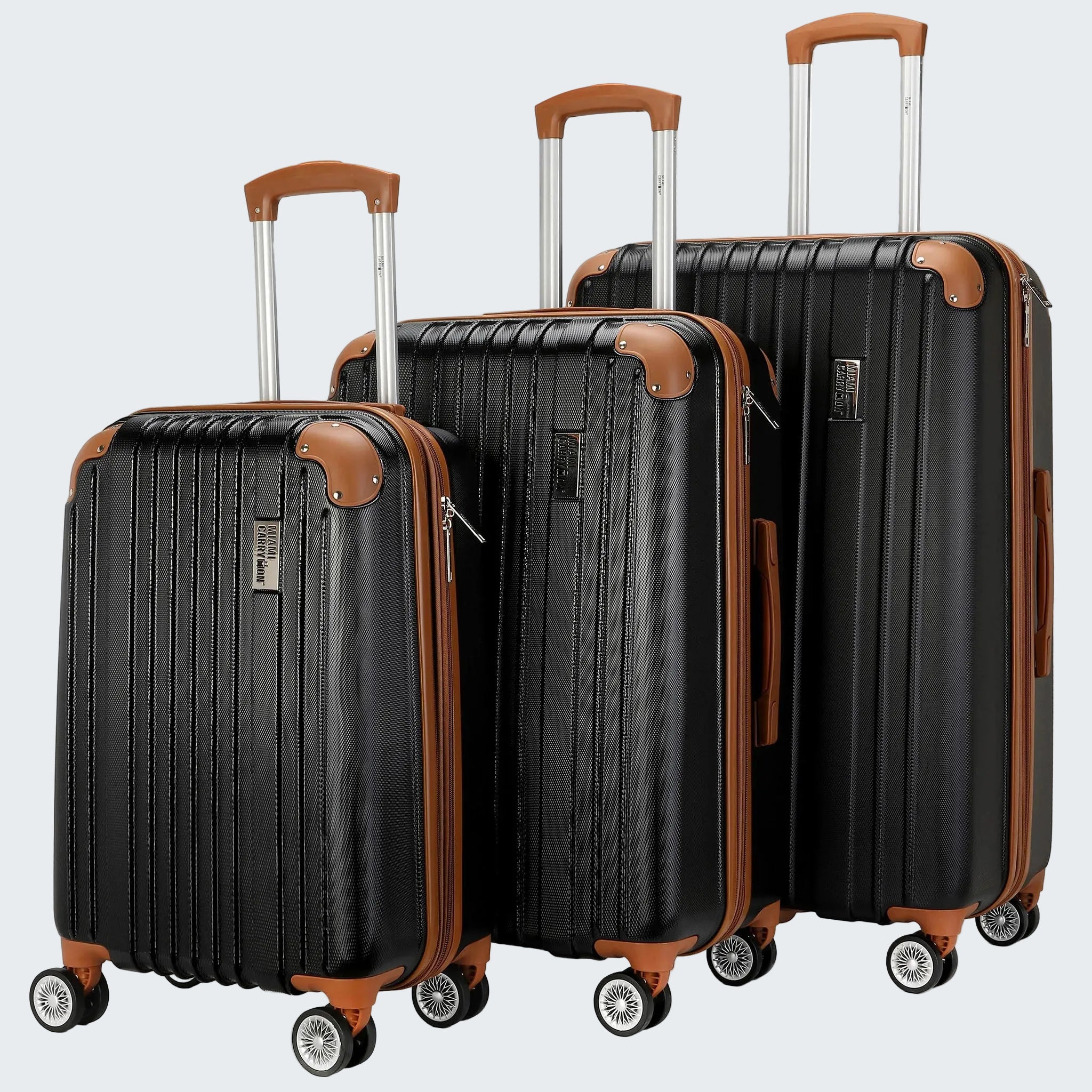 Set of black suitcases with brown accents on a white background