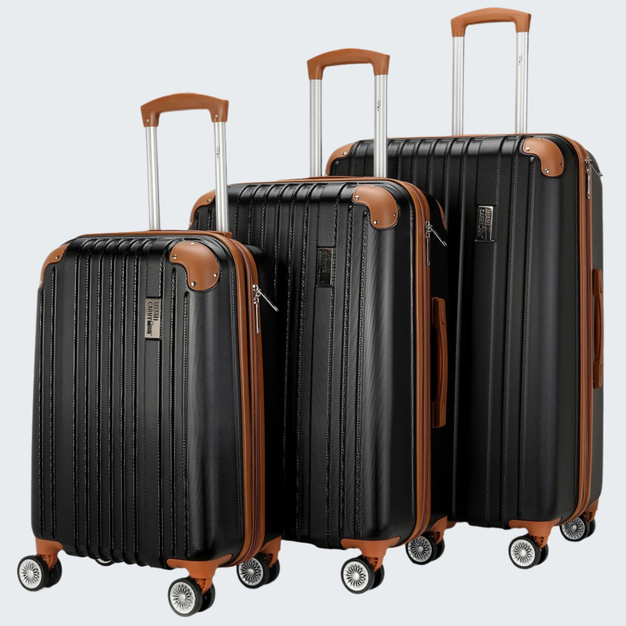 A set of three black retro-style luggage suitcases with expandable compartments and spinner wheels, featuring a textured surface and brown accents on corners and handles.