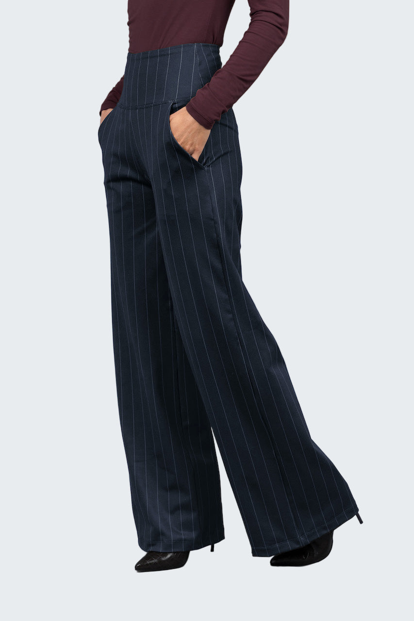Navy pinstripe pants worn by a person on a light gray background