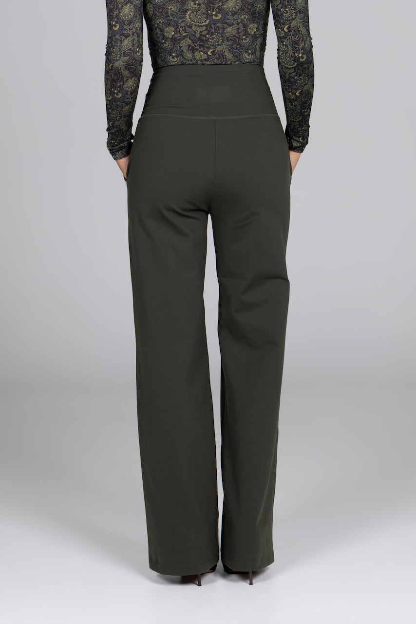 Dark green pants worn by a person on a white background