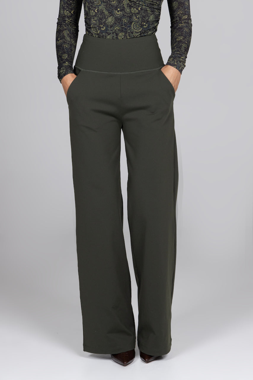 Dark green wide-leg pants worn by a person on a gray background