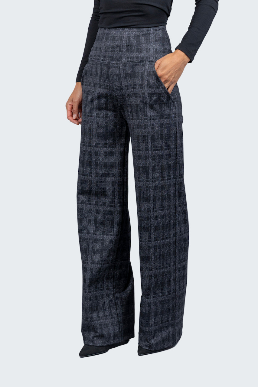 Plaid pants worn by a person on a gray background