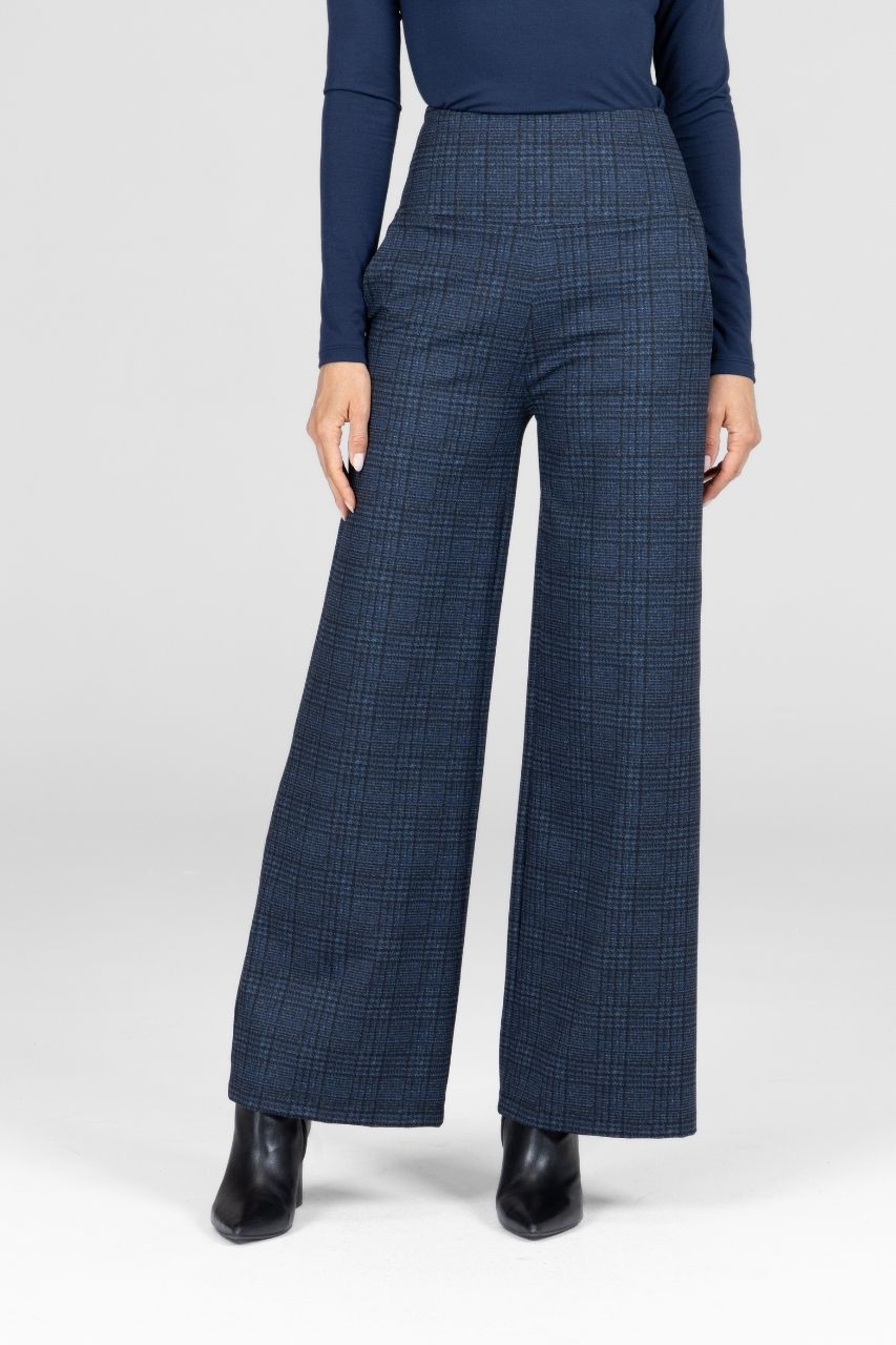 Person wearing blue checkered pants and a matching top on a white background