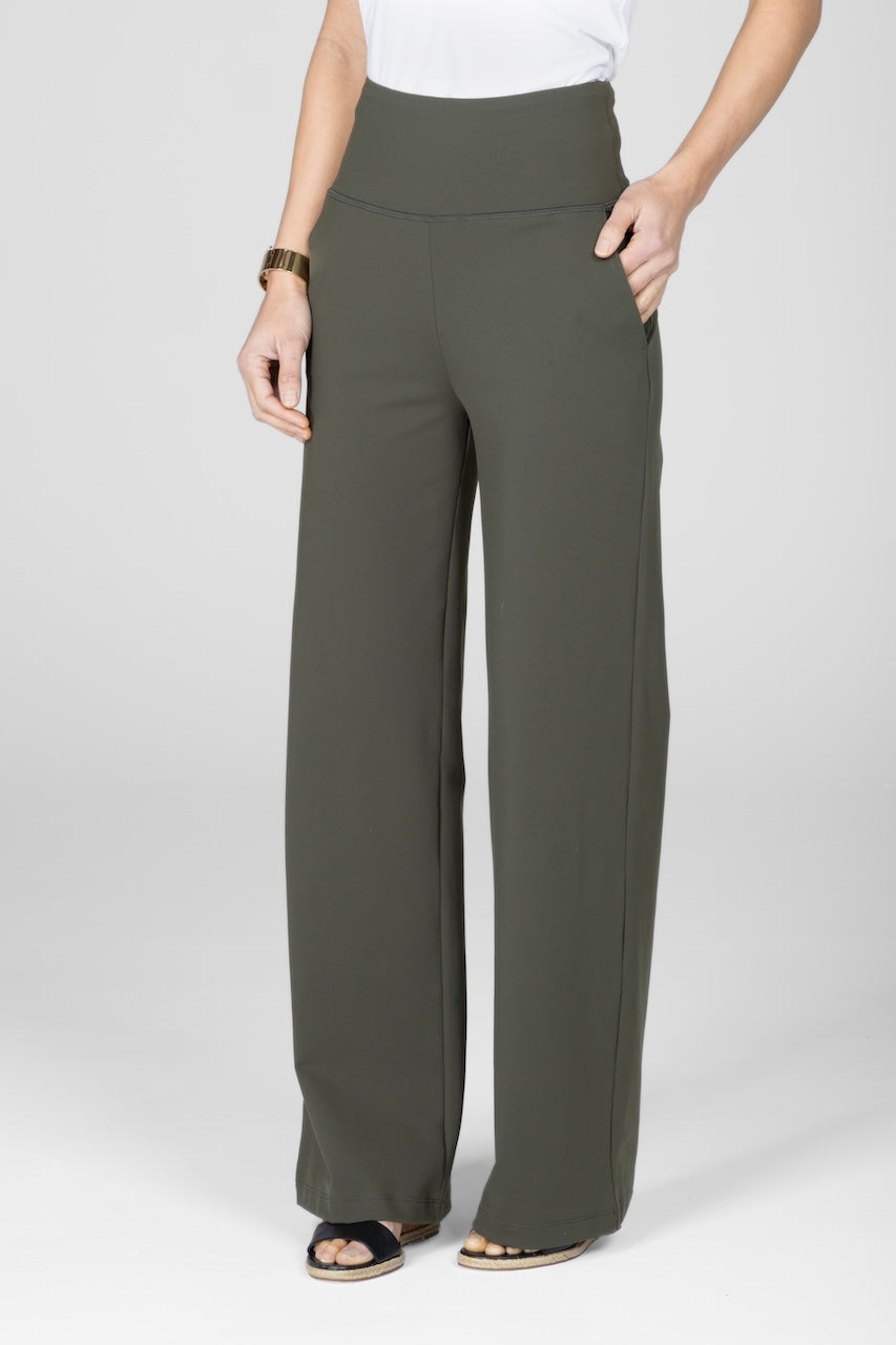 Person wearing olive green wide-leg pants on a white background