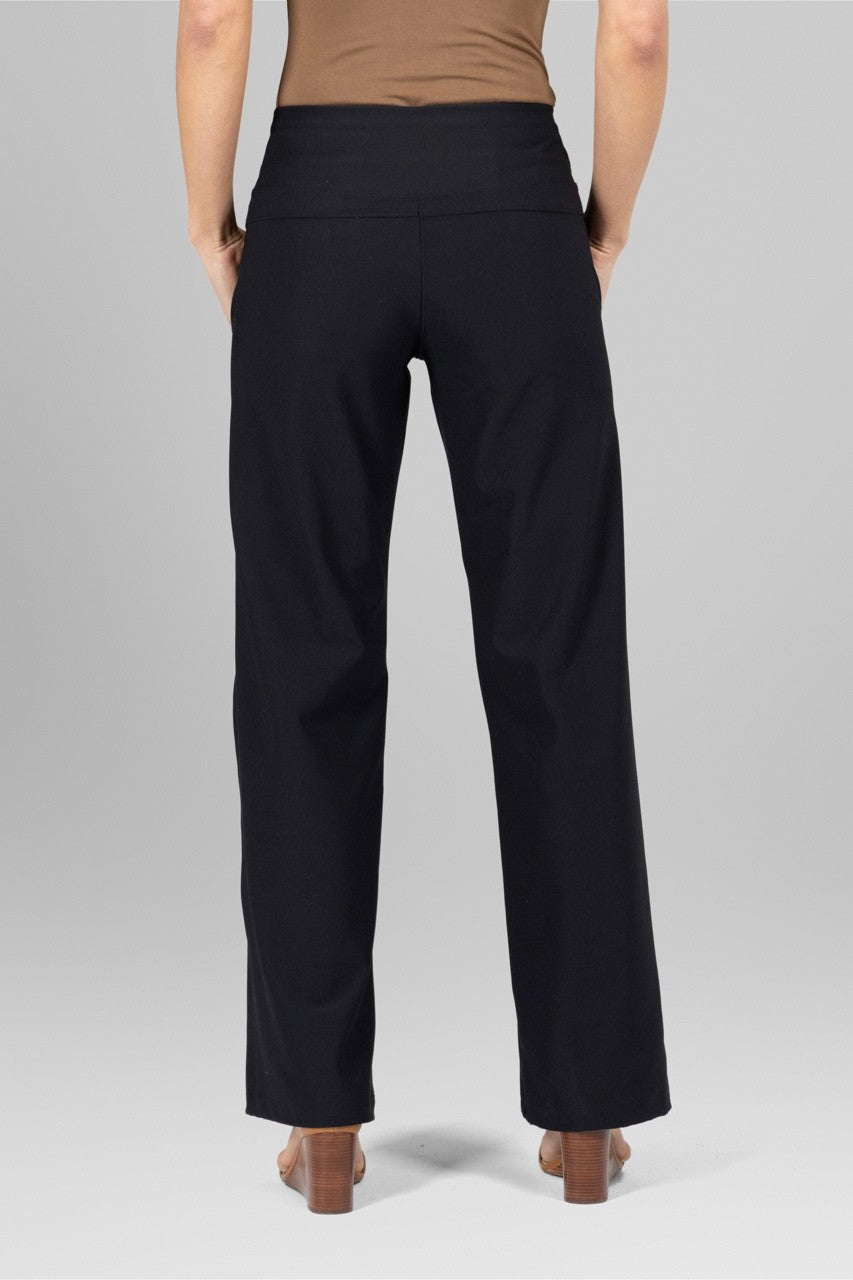 Black pants worn by a person on a gray background