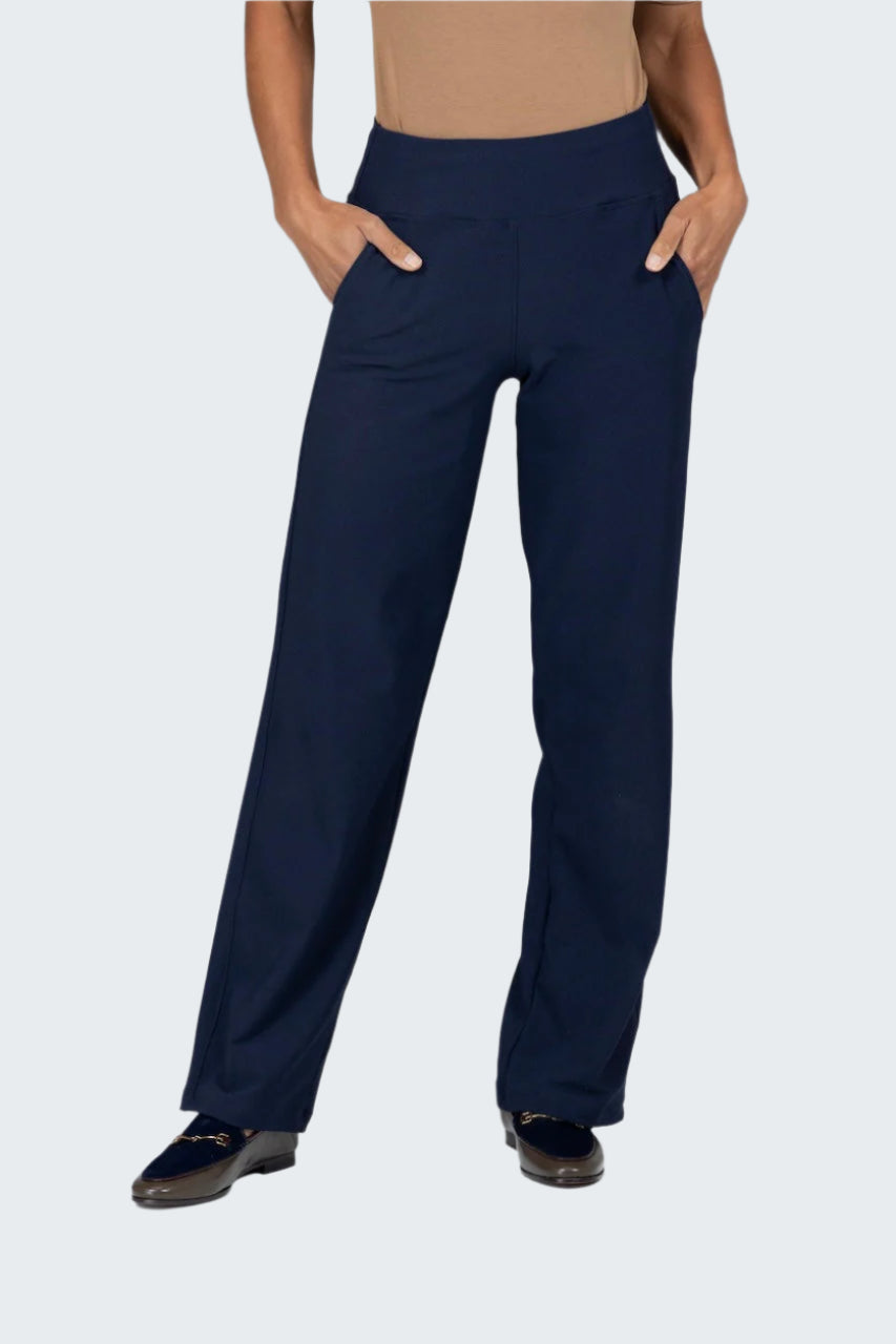 Navy blue pants worn by a person on a gray background