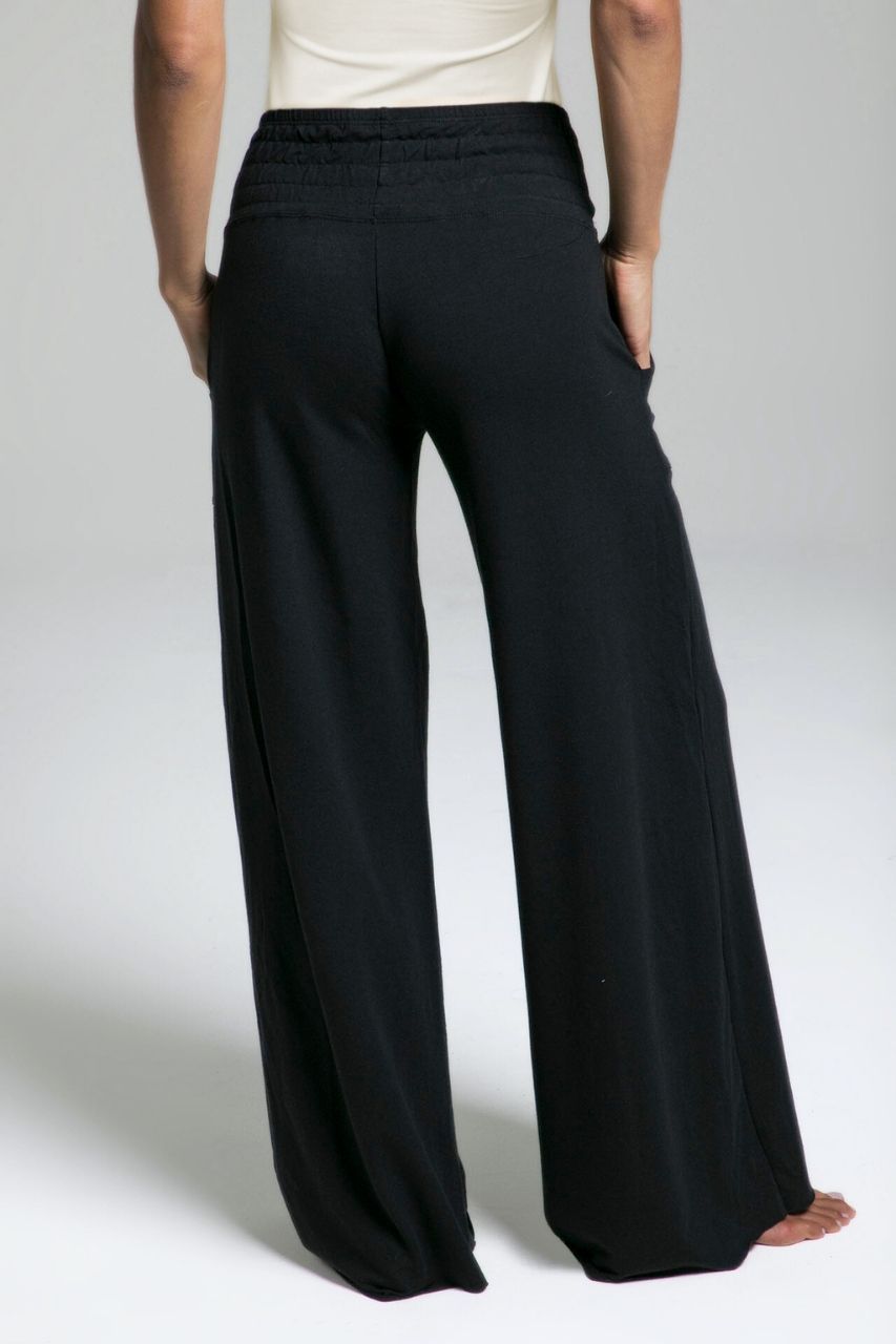 Black wide-leg pants worn by a person on a plain background