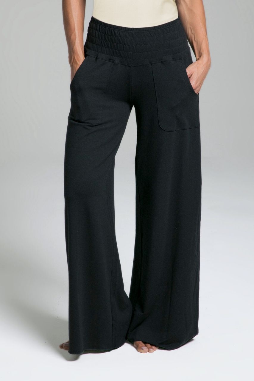 Black wide-leg pants worn by a person on a plain background