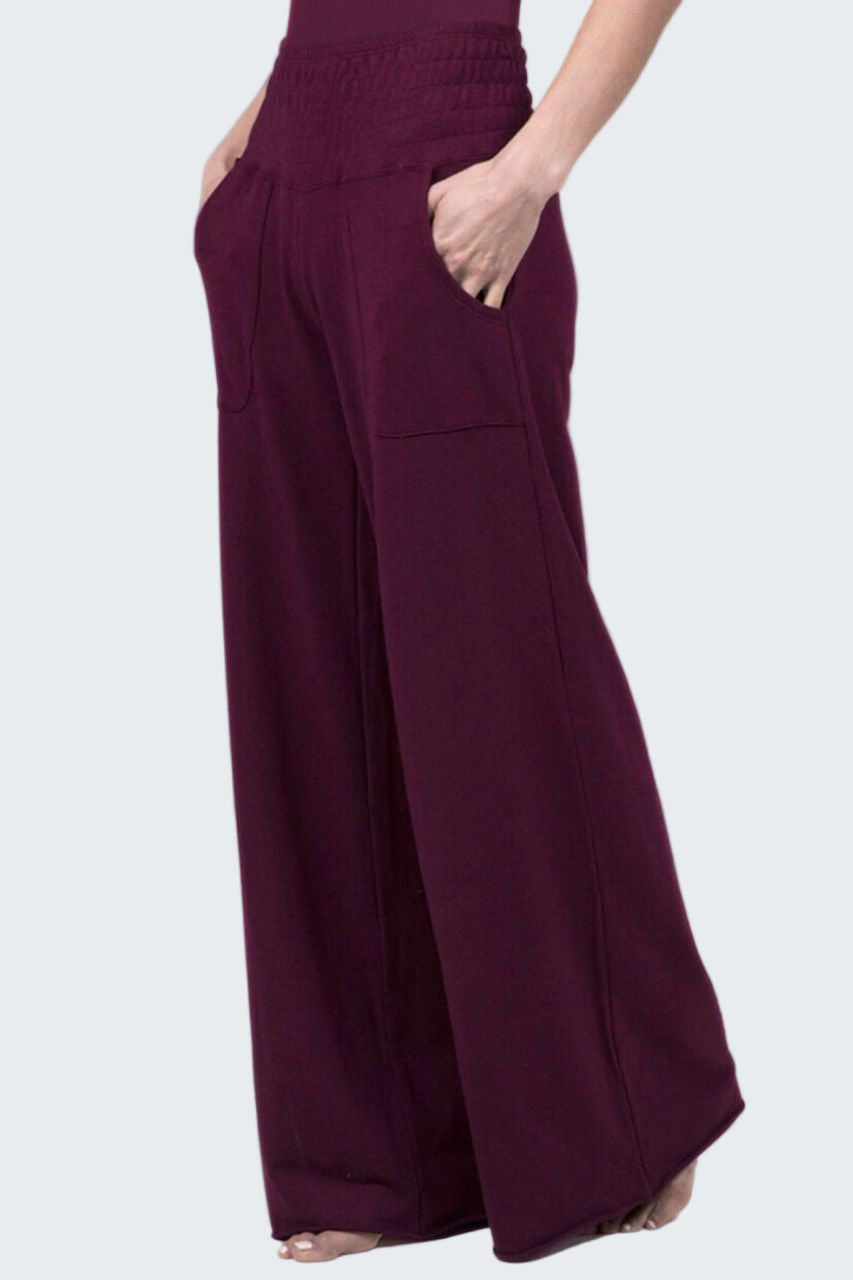 Maroon wide-leg pants worn by a person on a white background